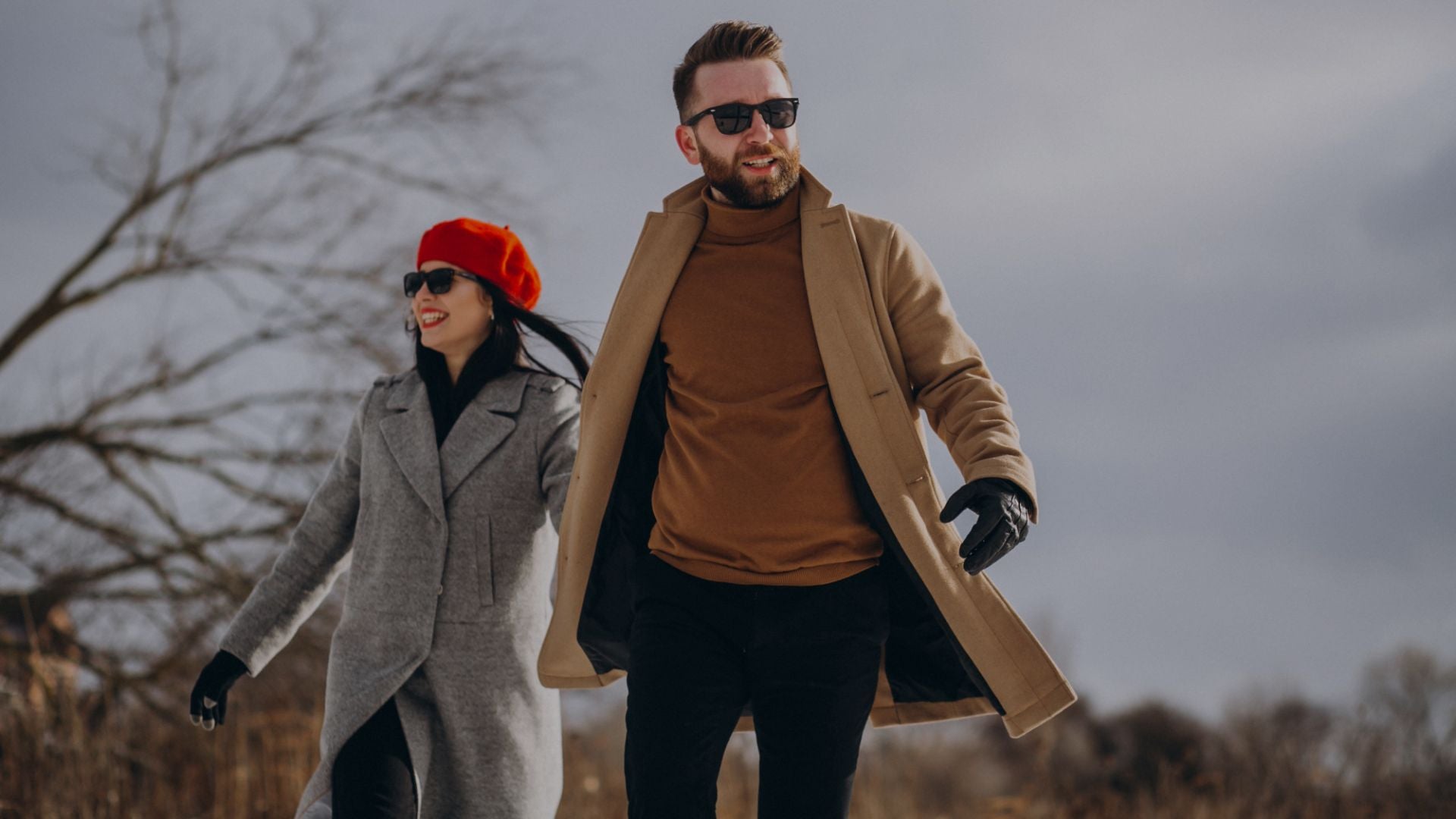 Man and woman walking outdoors wearing stylish winter clothing