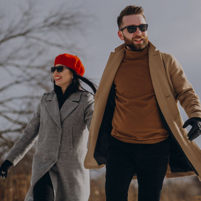 Man and woman walking outdoors wearing stylish winter clothing